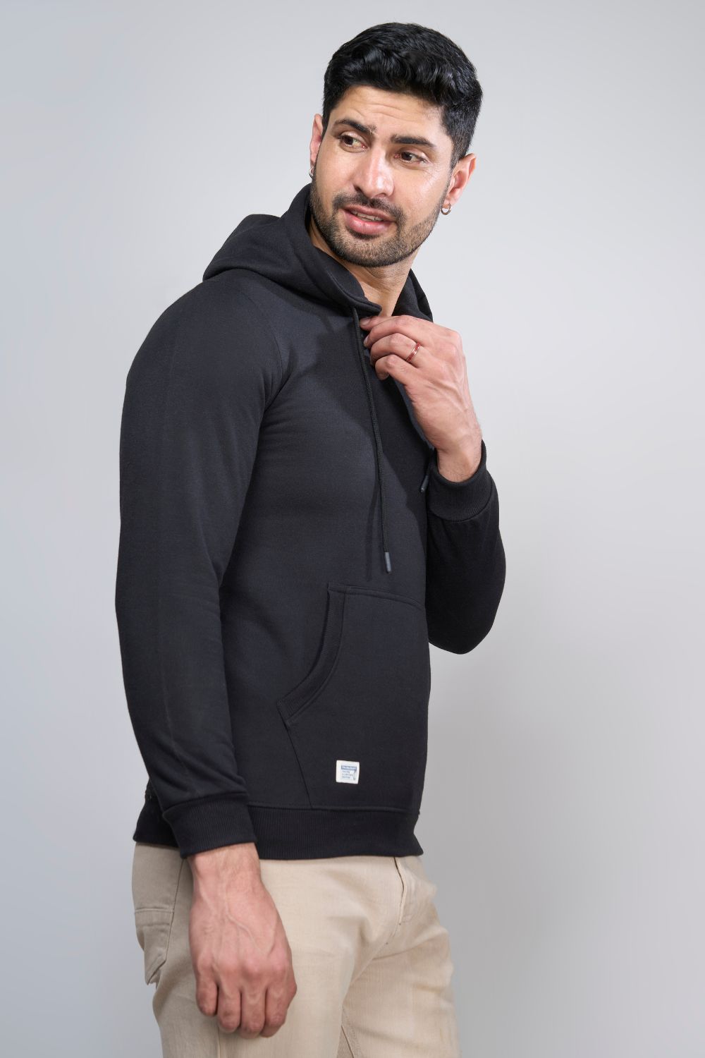 Black colored, hoodie for men with full sleeves and relaxed fit, Pocket view.