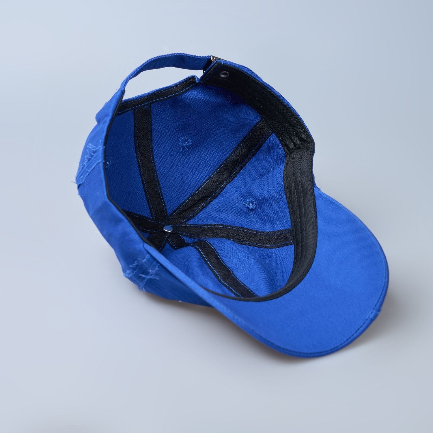 Blue colored, wide brim cap for men with adjustable strap, inside view.