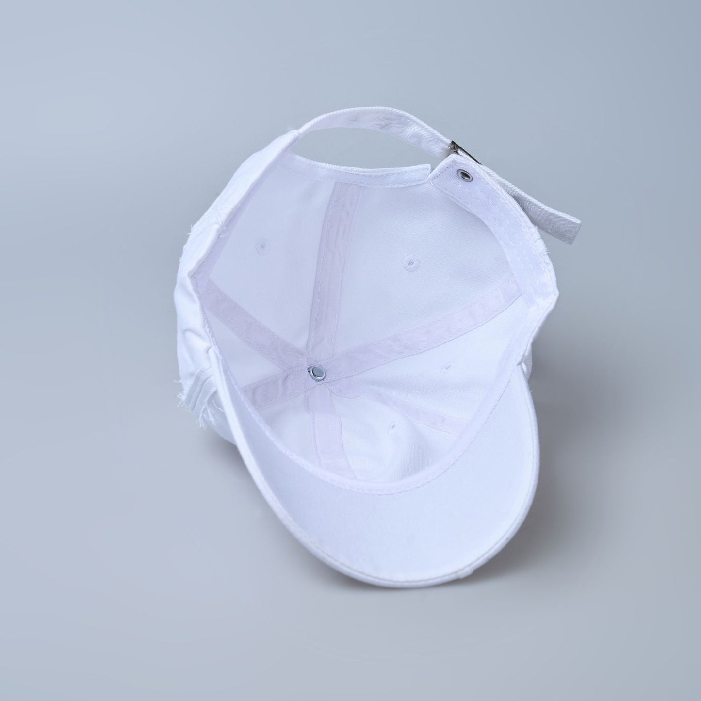 white colored, wide brim polo cap for men with adjustable strap, inside.
